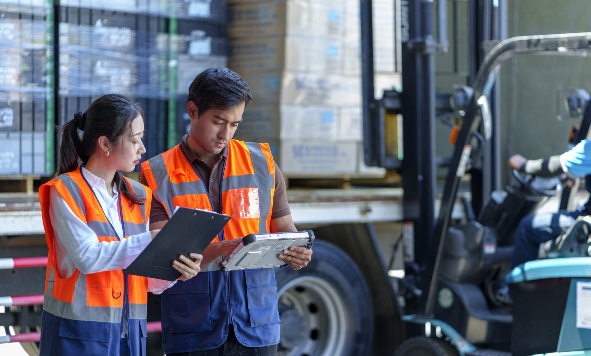 Logistics managers look at clipboards.