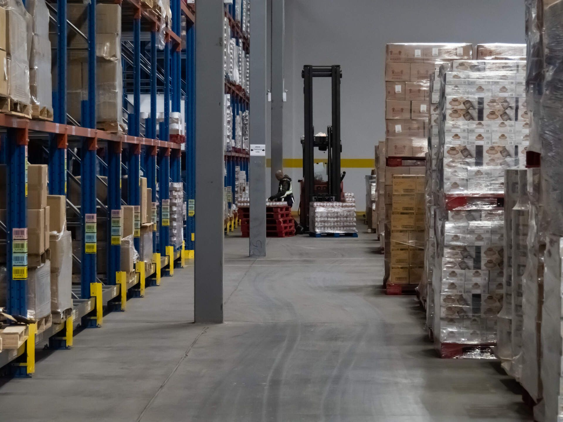 A warehouse with shelving and inventory demonstrating a pick and pack operation.